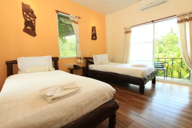 Superior Twin Room with twin beds, wooden furnishings, and nature balcony view — Gallery image 1
