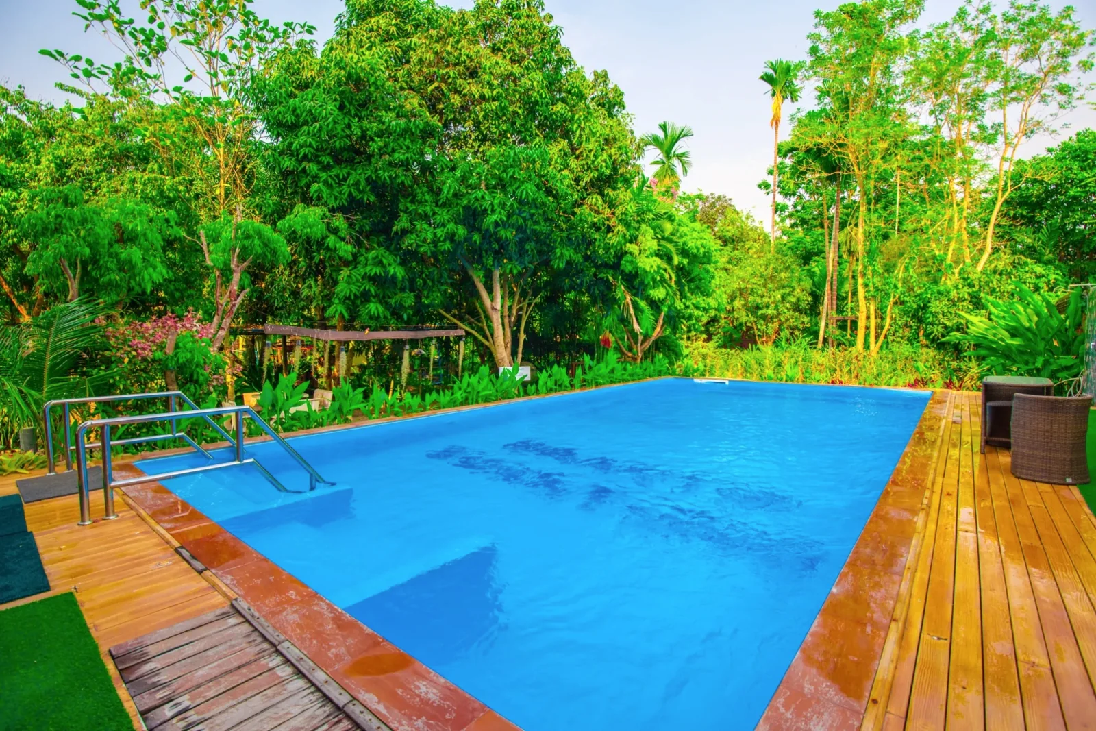 Baantip's outdoor pool surrounded by garden greenery